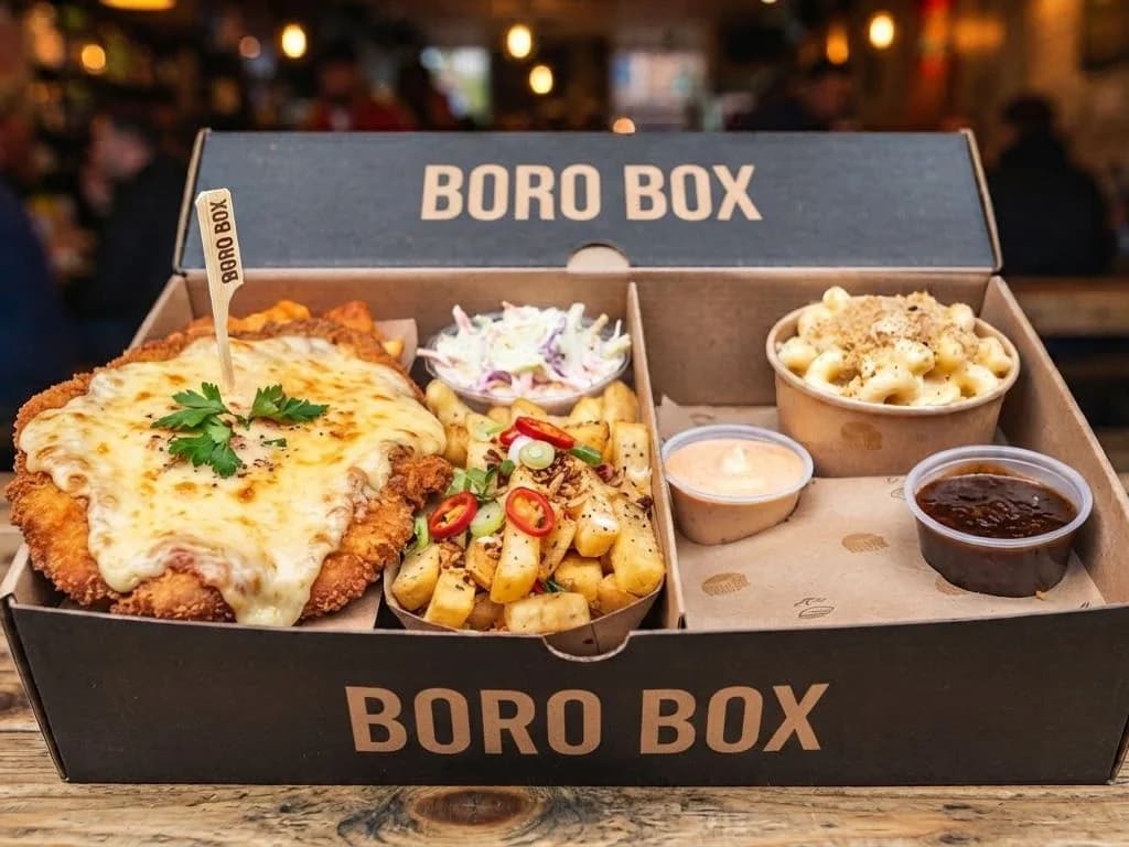 Boro Box - a cheese-topped Teesside parmo with salt n pepper chips, house slaw, mac n cheese and two dips in one branded box, from Ashville Hot Chicken, JLT Dubai