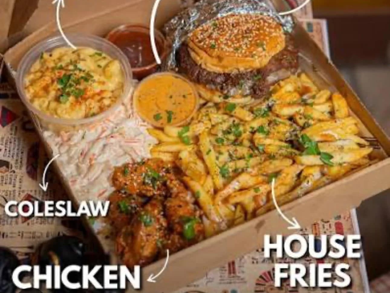 Bradford Box - a smash burger, hot honey chicken, house fries, coleslaw, mac and cheese and dips laid out in one box, from Ashville Hot Chicken, JLT Dubai