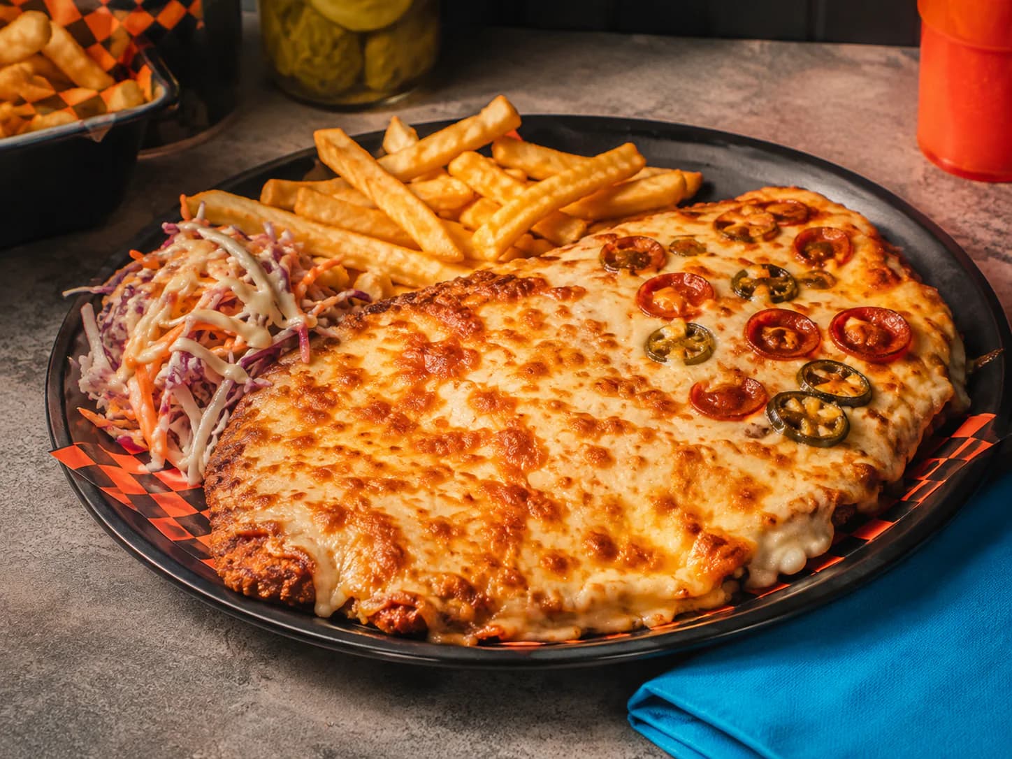 A proper Teesside chicken parmo topped with bechamel and melted cheese, made in JLT Dubai