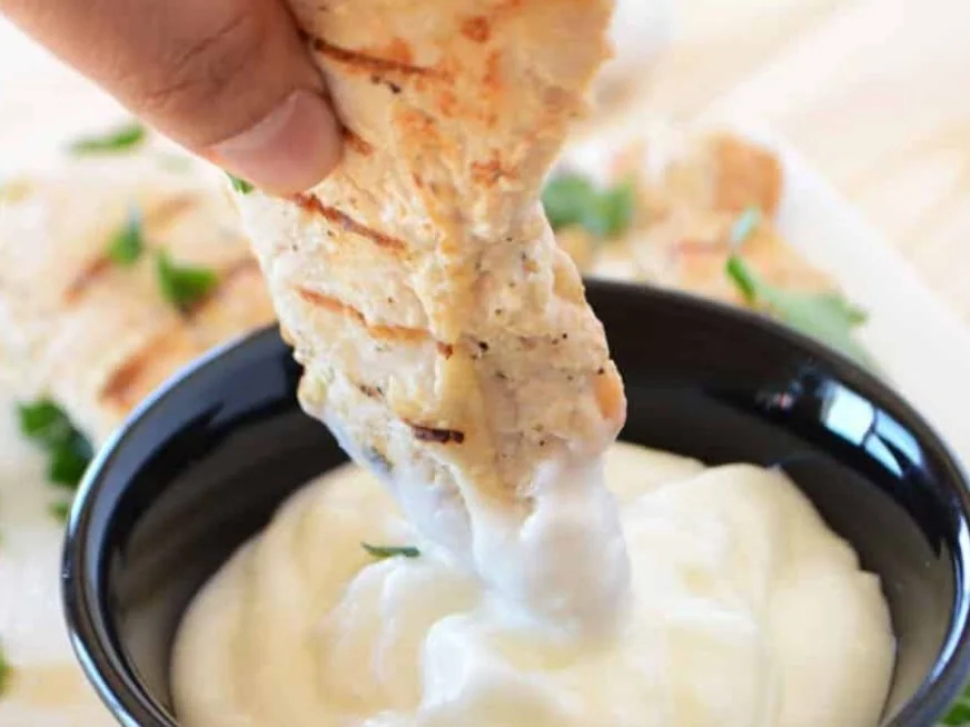 Dips - a strip of toasted bread dunked into a pot of creamy dip, from Ashville Hot Chicken, JLT Dubai