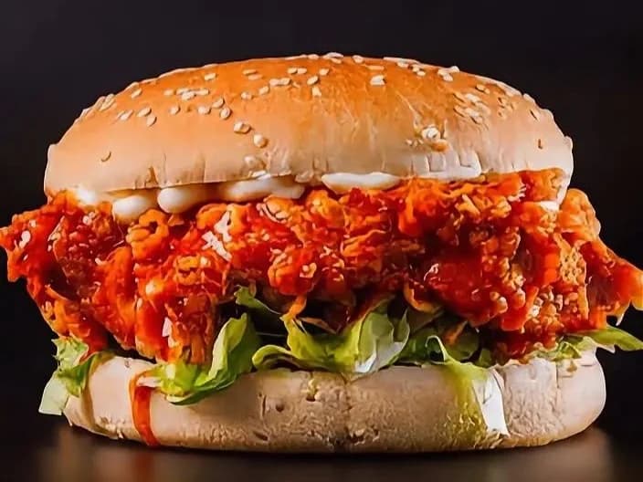 Manchester's Spicy Dip - fried chicken coated in fiery red spicy dip with lettuce and mayo in a seeded bun, from Ashville Hot Chicken, JLT Dubai