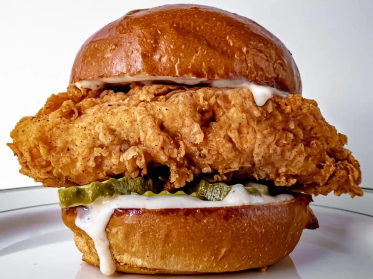 The OG Chic - a thick crispy fried chicken fillet with pickles and kraq sauce in a glazed bun, from Ashville Hot Chicken, JLT Dubai